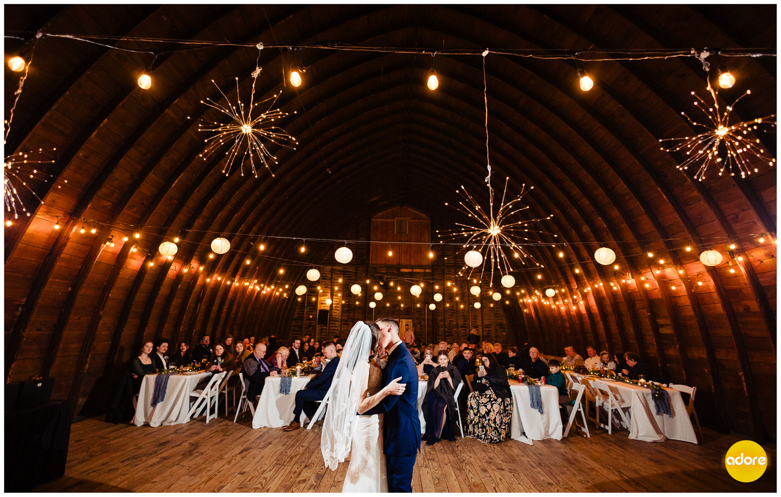 Bride and groom first dance and kiss under lights at winter barn wedding
Shade Rock Farms