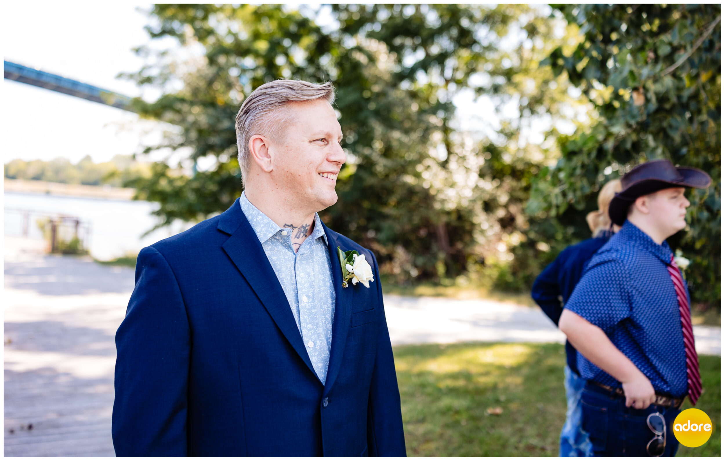 Groom watches bride waking towards him.